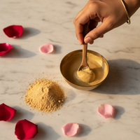 Hand mixing golden Chandan powder with rose petals