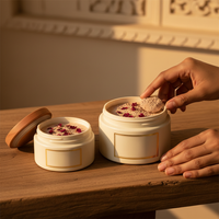 White round Multani Mitti clay mask jars on wooden shelf
